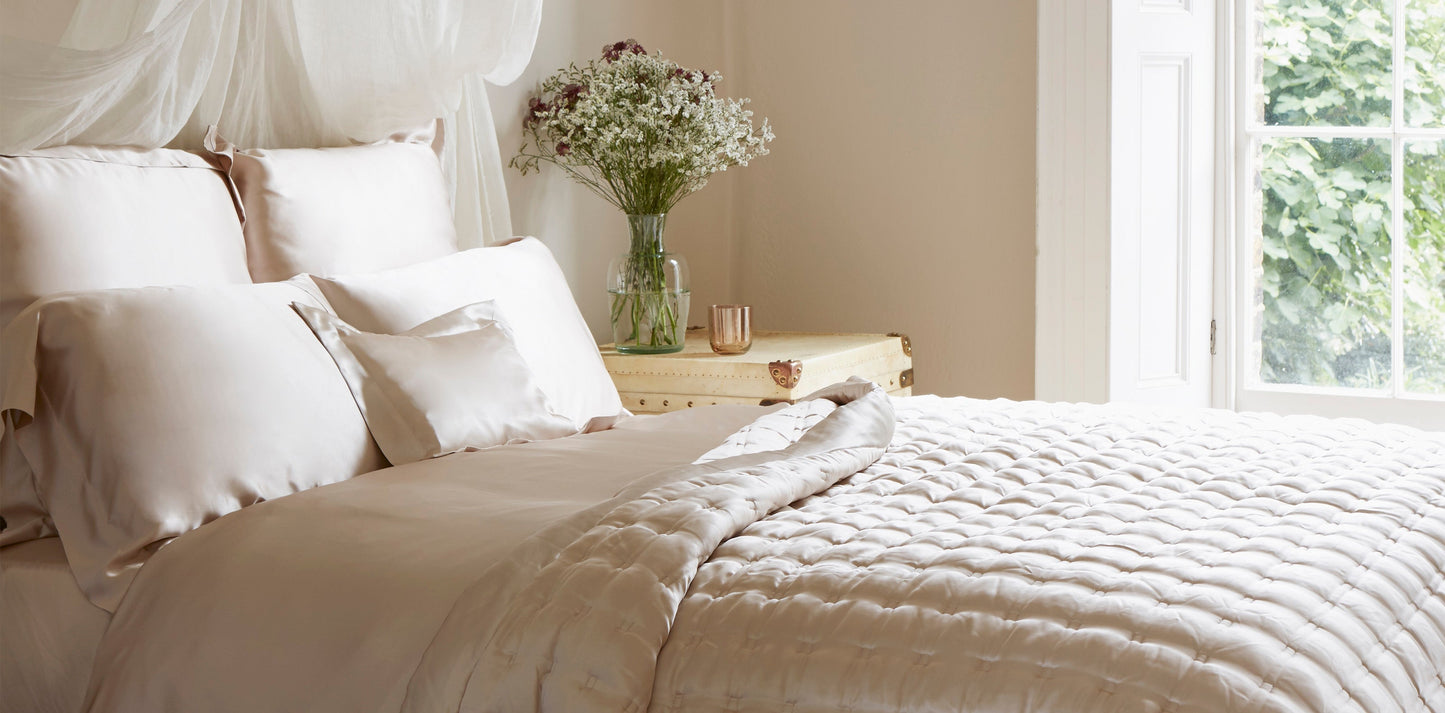 Fitted sheet made from blush colored silk fabric