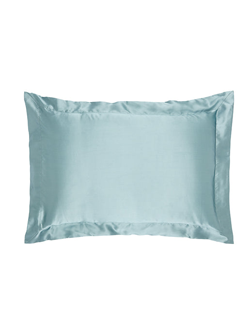 Teal silk pillowcase on a bed
